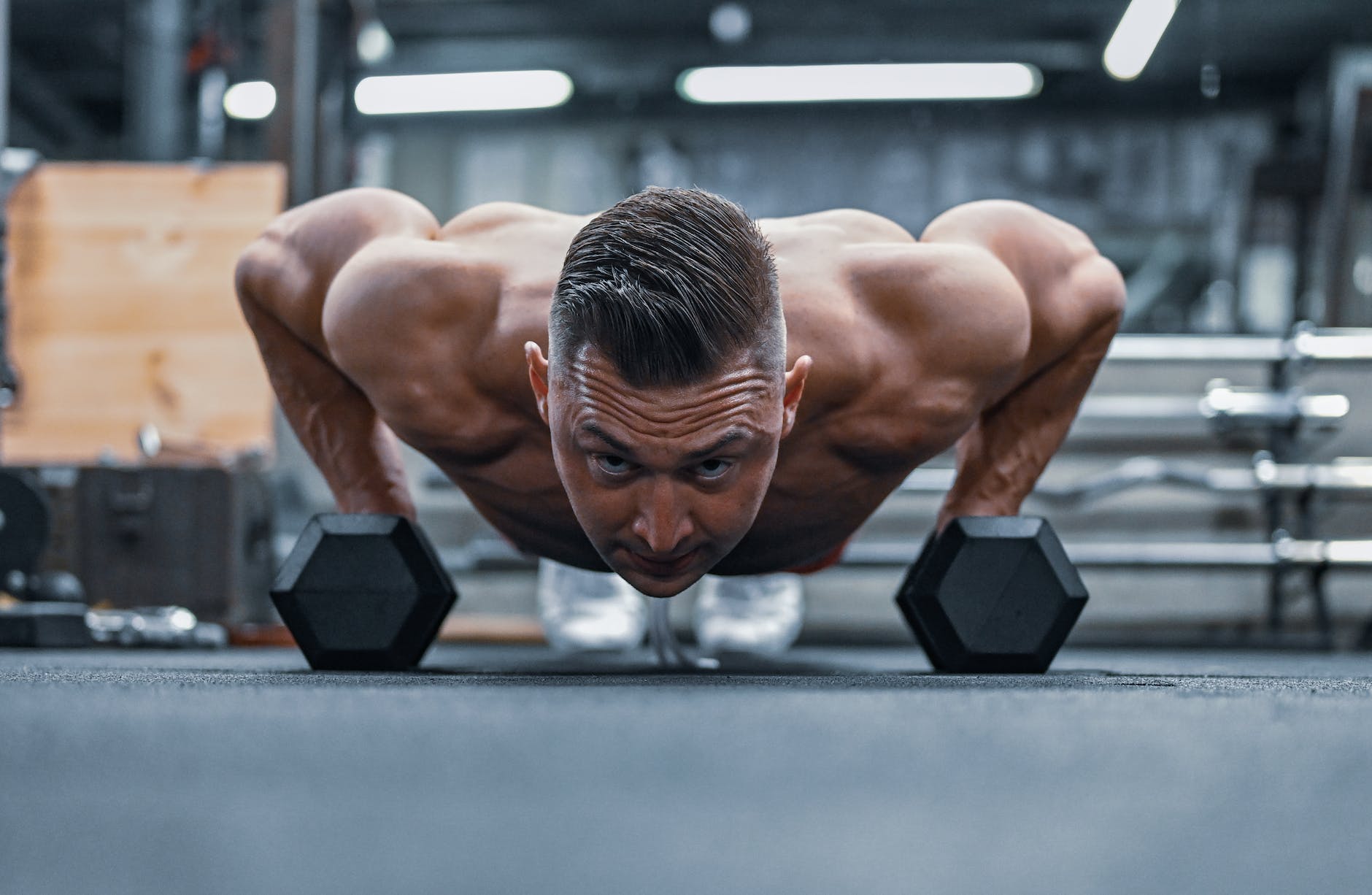 man doing a push up in a gym