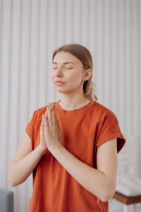 woman in red crew neck t shirt doing concentration exercise